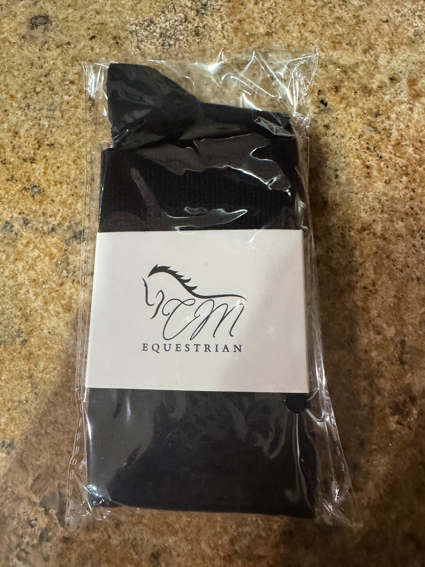 CM equestrian logo socks in black with White logo on the side.